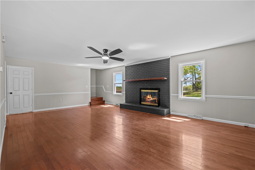 101 Maria Lane Seneca, SC 29678 - Photo 8 of 31 This inviting living space features gleaming hardwood floors and a cozy fireplace, perfect for relaxing.