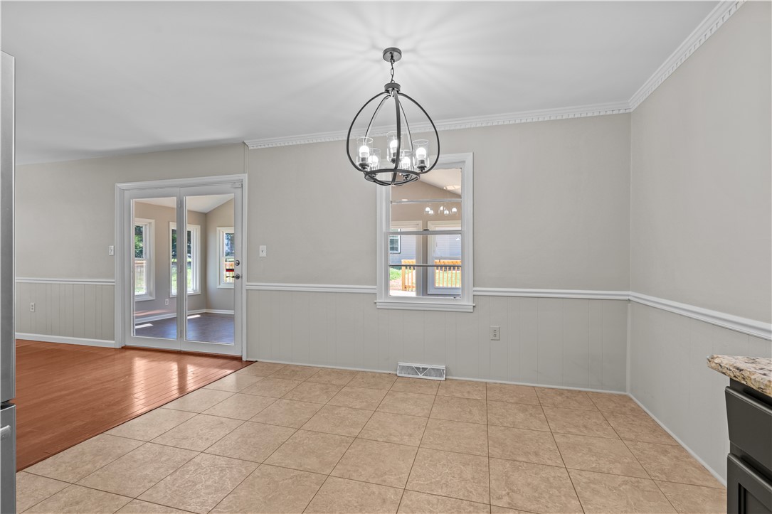 101 Maria Lane Seneca, SC 29678 - Photo 10 of 31 This bright dining area features an elegant chandelier and durable tile flooring, perfect for everyday living.