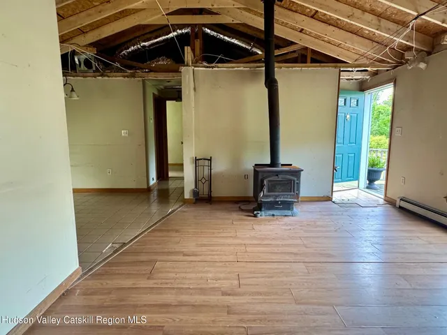 a view of a room with wooden floor and windows
