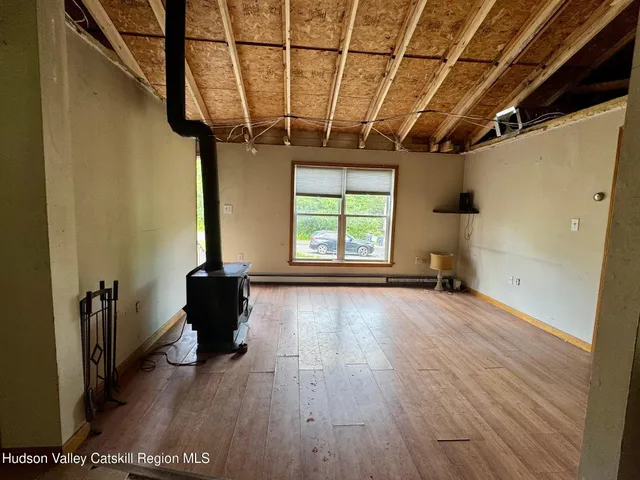a view of a livingroom with wooden floor and furniture