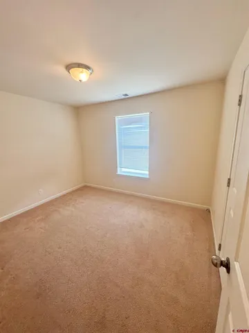 an empty room with a empty space and a window