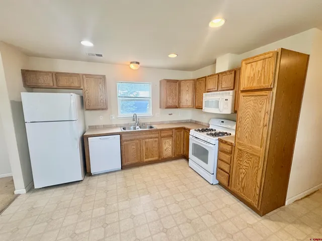 a kitchen with stainless steel appliances a refrigerator sink and microwave