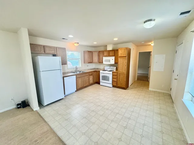 a kitchen with a refrigerator and microwave