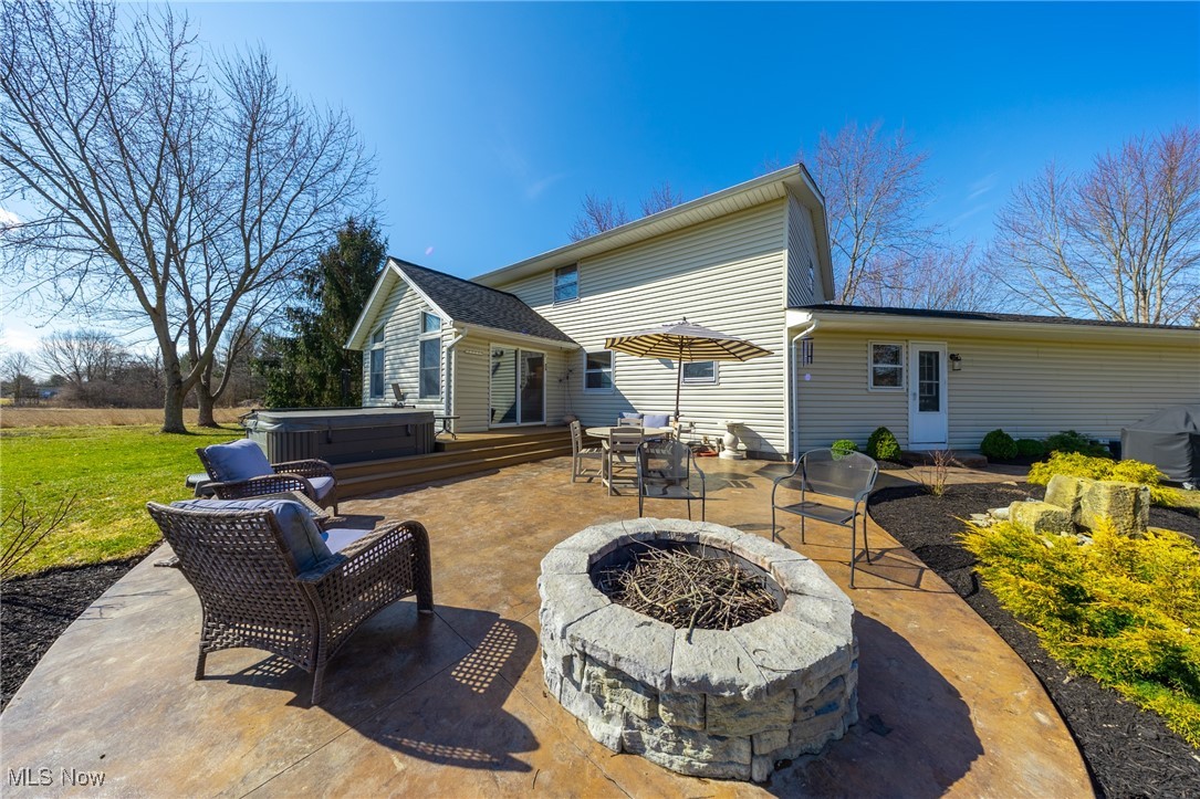 4515 State Road Medina, OH 44256 - Photo 34 of 36 Back of property featuring a fire pit, a patio area, and a hot tub