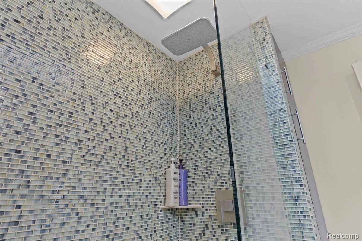 43 Wellesley Drive Pleasant Ridge, MI 48069 - Photo 30 of 52 Shower featuring glass mosaic tile, a rain shower head, a glass enclosure, and a built-in corner shelf