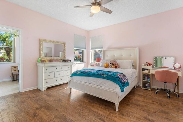 a bedroom with a bed and a chair