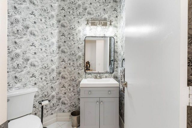 a bathroom with a sink a toilet and mirror