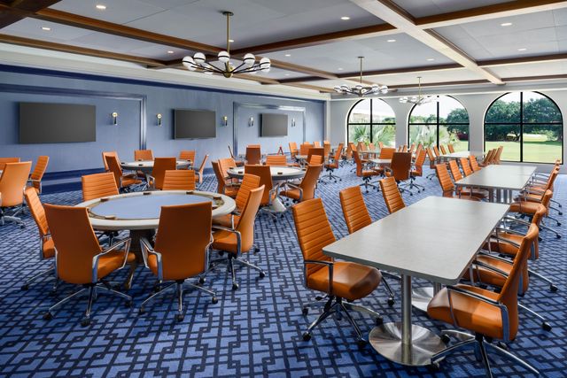 a view of a dining room with furniture a chandelier and wooden floor