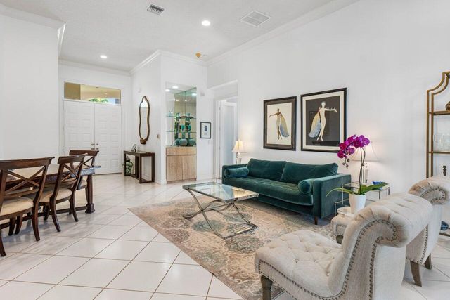 a living room with furniture and a dining table with kitchen view