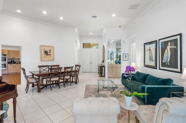 a living room with furniture and flowers