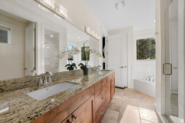 1238 Canyon View Road Midway, UT 84049 - Photo 22 of 33 Spa-inspired primary bathroom featuring a dual-sink vanity with warm wood cabinetry, granite countertops, and brushed nickel hardware