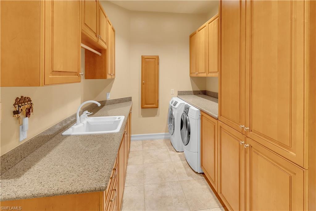 14600 Fritchey Road Naples, FL 34114 - Photo 13 of 44 a kitchen with a sink stove and a refrigerator
