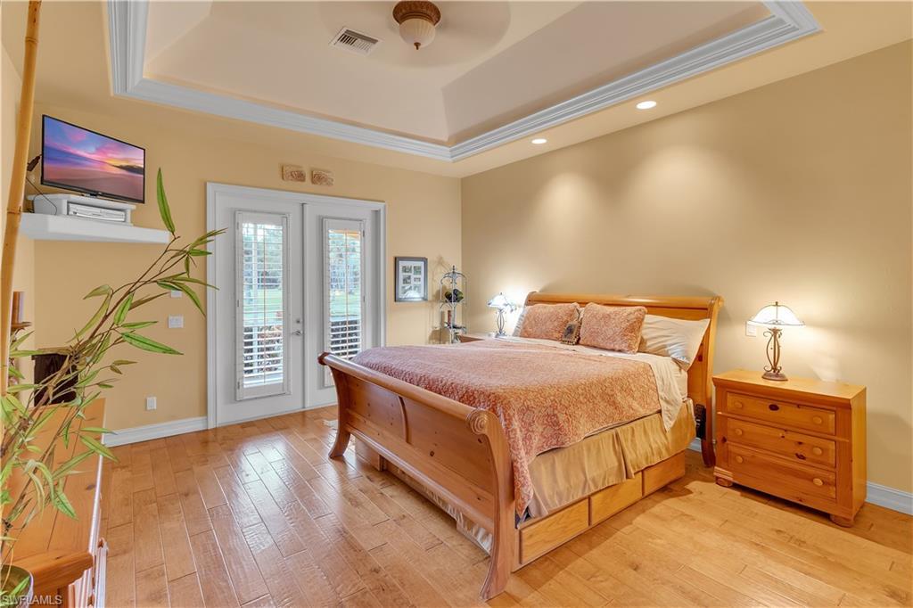 14600 Fritchey Road Naples, FL 34114 - Photo 14 of 44 a bedroom with a bed and a tv on the dresser