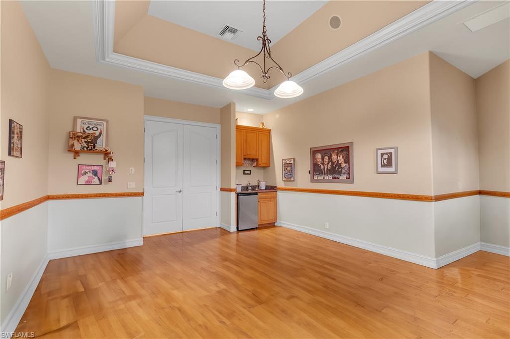 14600 Fritchey Road Naples, FL 34114 - Photo 17 of 44 a bedroom with a large bed and a chandelier