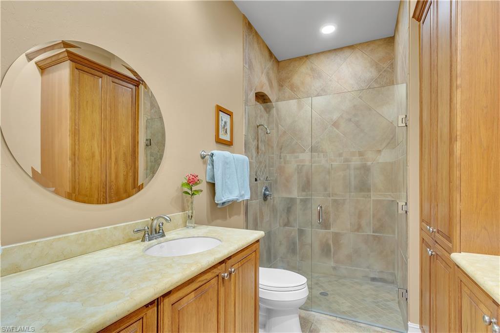 14600 Fritchey Road Naples, FL 34114 - Photo 20 of 44 a bathroom with a granite countertop sink a toilet and shower