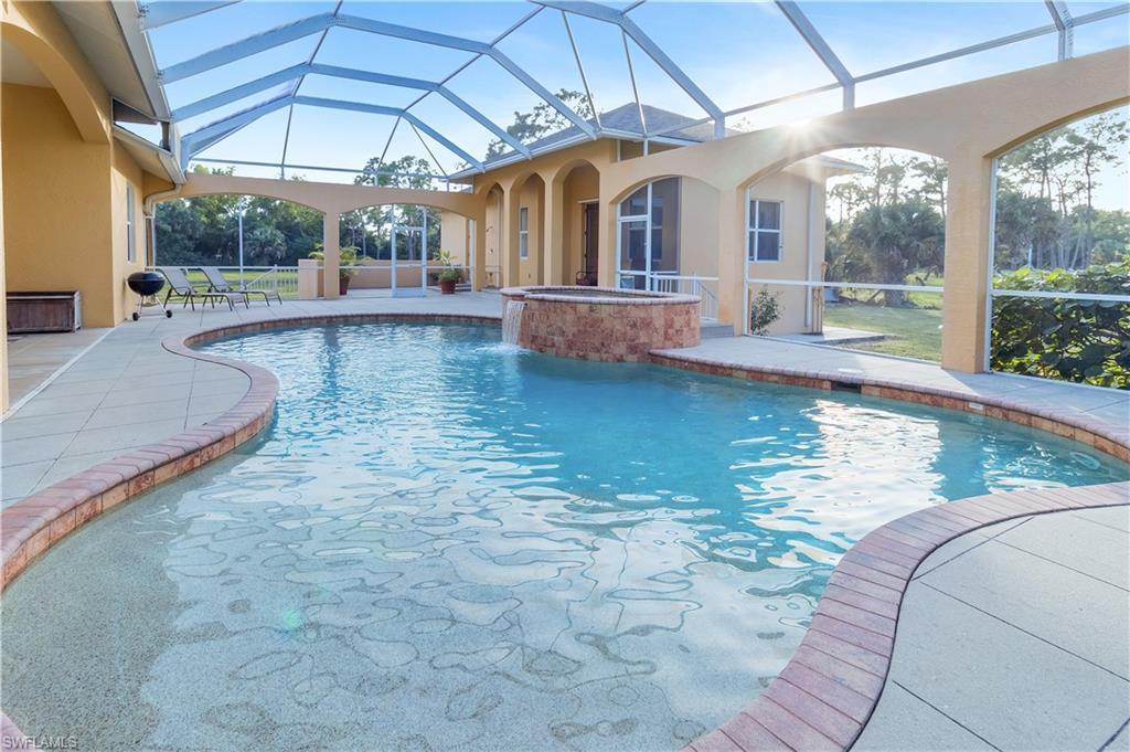 14600 Fritchey Road Naples, FL 34114 - Photo 23 of 44 a view of a swimming pool with a porch