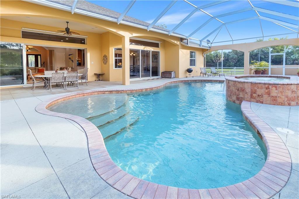 14600 Fritchey Road Naples, FL 34114 - Photo 25 of 44 a view of a swimming pool with outdoor seating