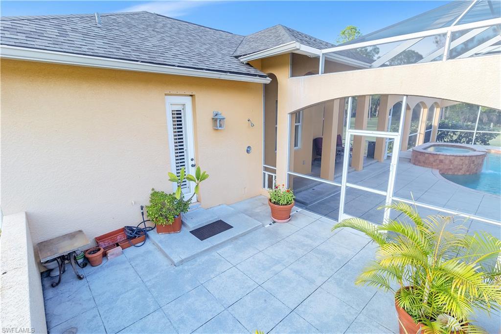 14600 Fritchey Road Naples, FL 34114 - Photo 26 of 44 a front view of a house with a garden