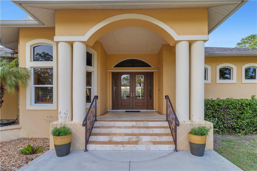 14600 Fritchey Road Naples, FL 34114 - Photo 3 of 44 a front view of a house with a porch