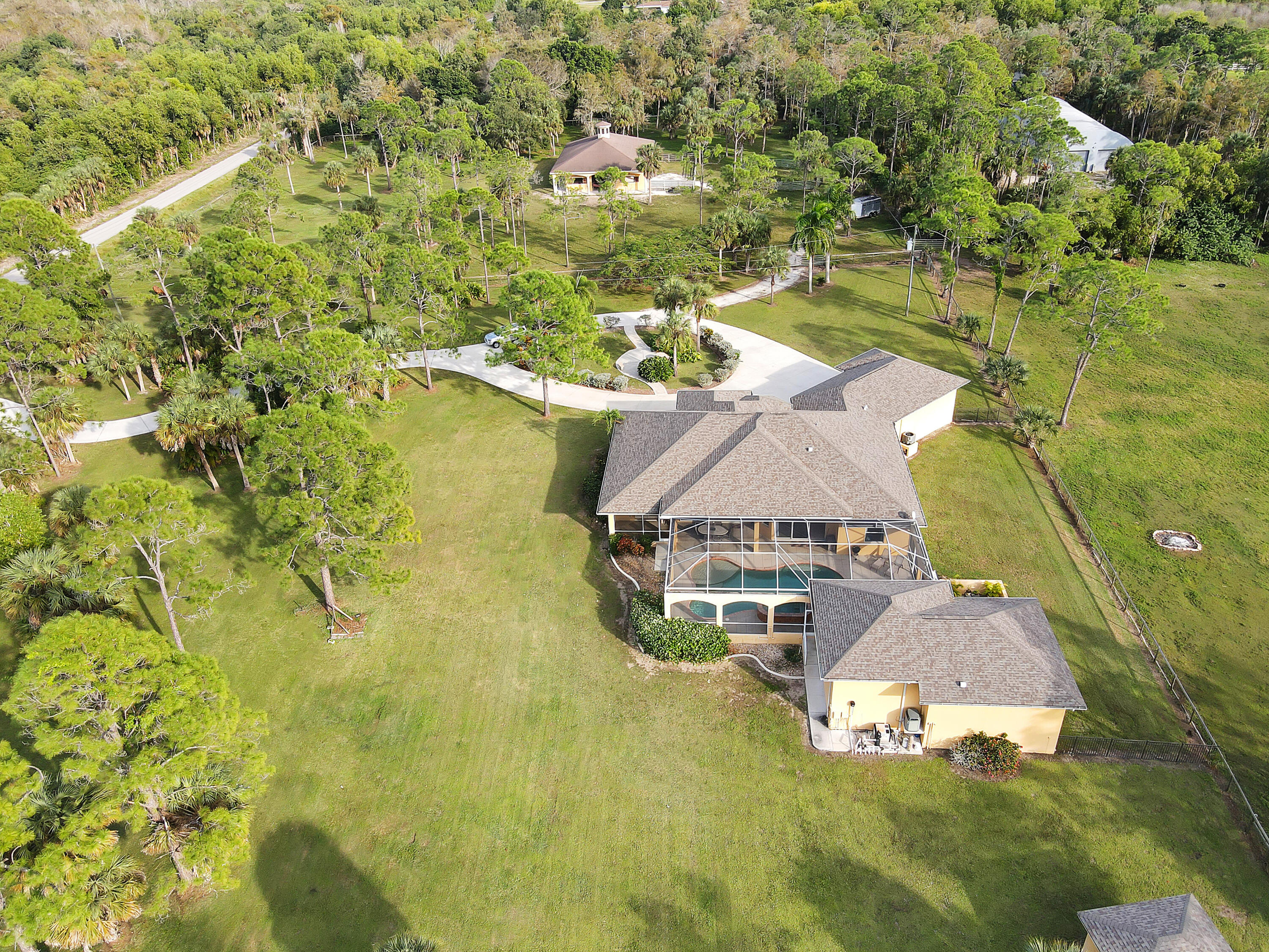 14600 Fritchey Road Naples, FL 34114 - Photo 31 of 44 an aerial view of residential houses with outdoor space and trees