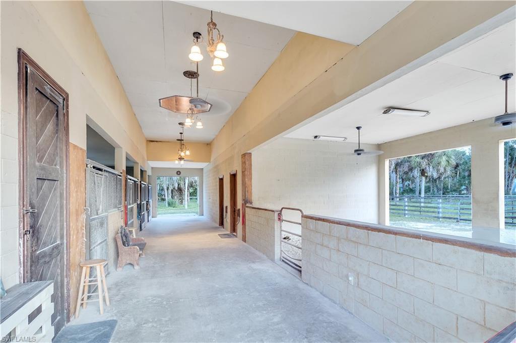 14600 Fritchey Road Naples, FL 34114 - Photo 38 of 44 a view of a hallway with chandelier