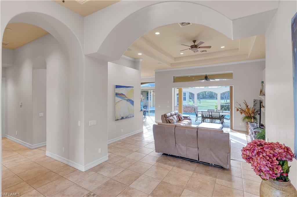 14600 Fritchey Road Naples, FL 34114 - Photo 6 of 44 a living room with furniture and a chandelier