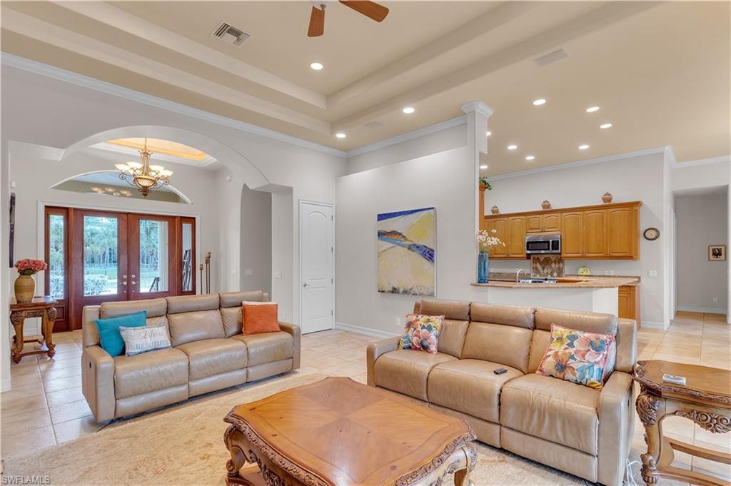 14600 Fritchey Road Naples, FL 34114 - Photo 9 of 44 a living room with furniture and a chandelier