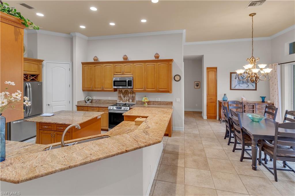 14600 Fritchey Road Naples, FL 34114 - Photo 10 of 44 a living room with dining room and chandelier