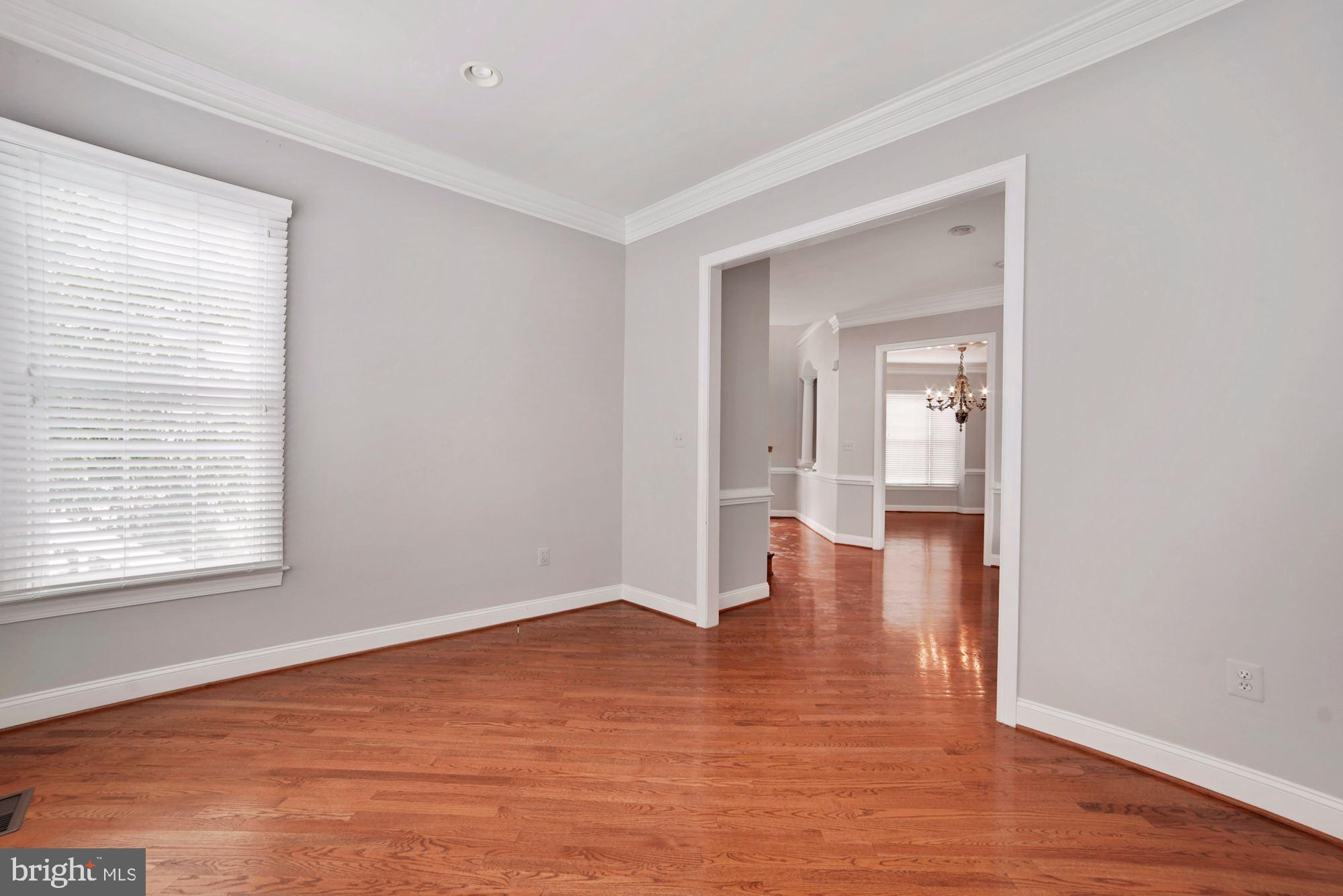 8238 Snead Loop Gainesville, VA 20155 - Photo 19 of 49 a view of empty room with wooden floor and a window