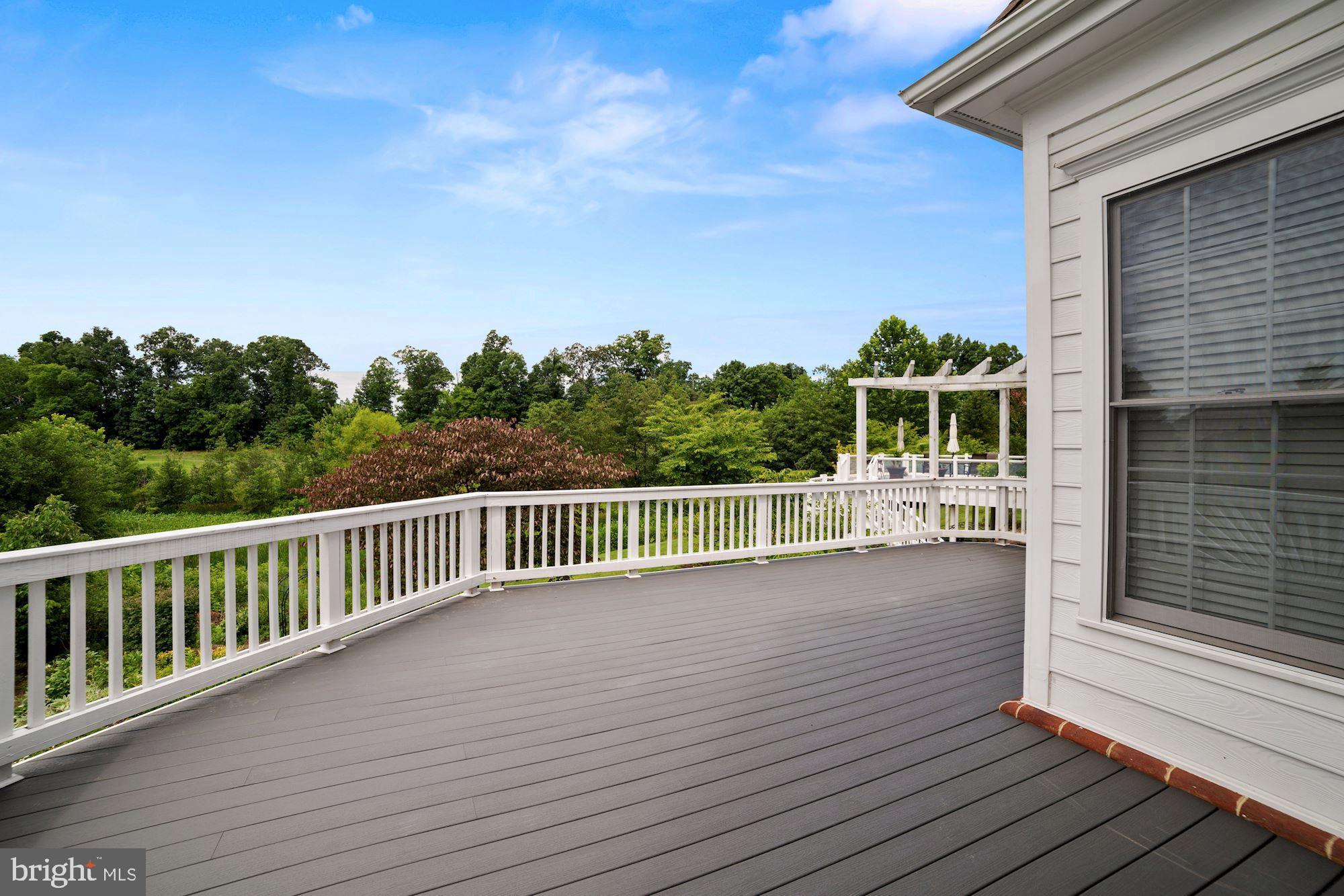 8238 Snead Loop Gainesville, VA 20155 - Photo 37 of 49 a view of a balcony with wooden floor and fence