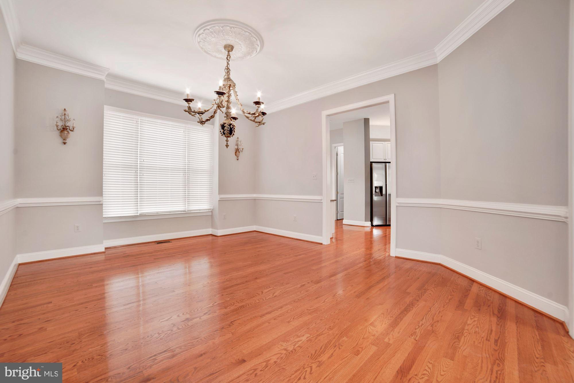 8238 Snead Loop Gainesville, VA 20155 - Photo 7 of 49 wooden floor in an empty room with a window
