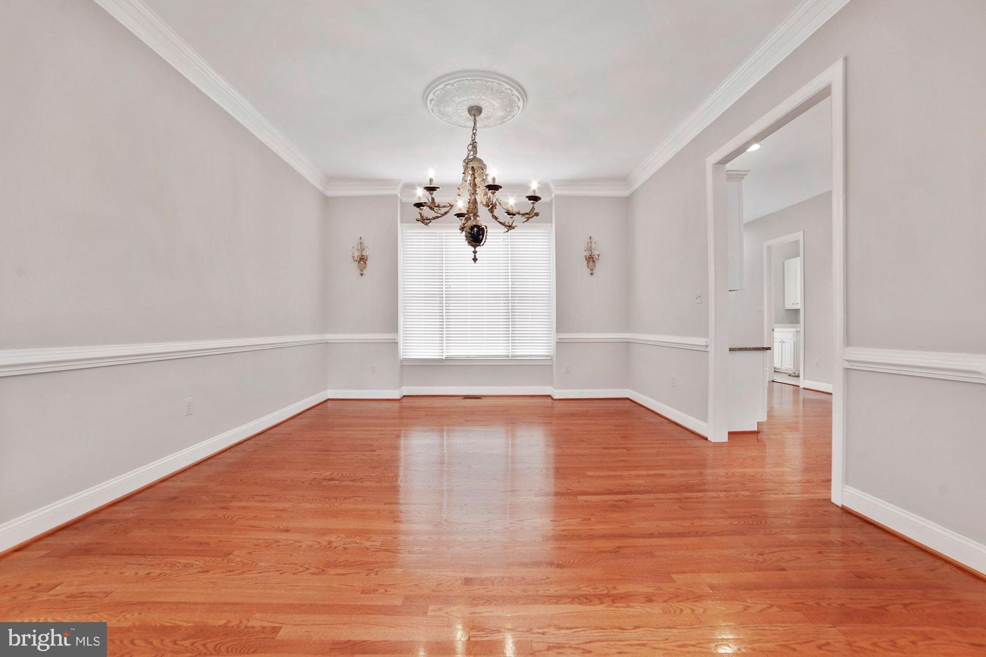 8238 Snead Loop Gainesville, VA 20155 - Photo 8 of 49 a view of empty room with wooden floor and fan