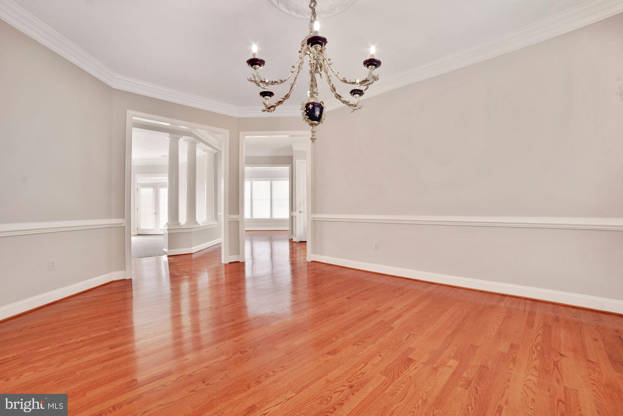 8238 Snead Loop Gainesville, VA 20155 - Photo 9 of 49 a view of an empty room with wooden floor and a window