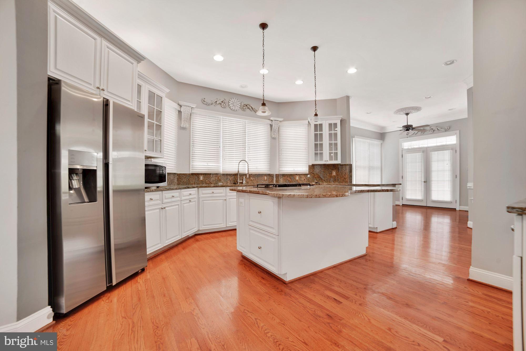 8238 Snead Loop Gainesville, VA 20155 - Photo 10 of 49 a kitchen with stainless steel appliances a refrigerator sink and cabinets