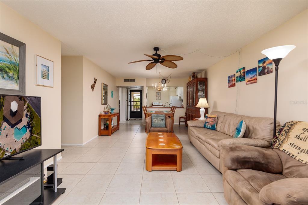 12300 Vonn Road, Unit 6303 Largo, FL 33774 - Photo 12 of 36 a living room with furniture and a flat screen tv