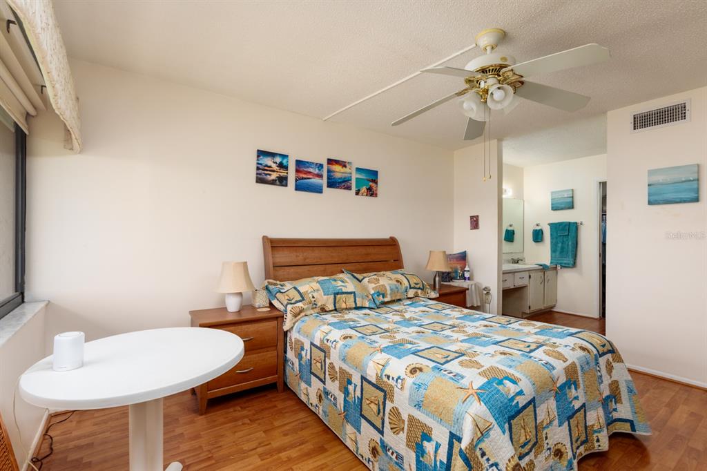 12300 Vonn Road, Unit 6303 Largo, FL 33774 - Photo 17 of 36 a bedroom with a bed and a chandelier