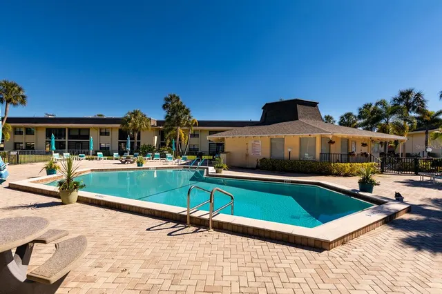 a swimming pool with outdoor seating and yard