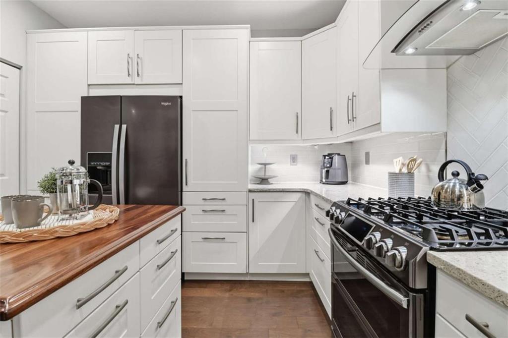 3047 Lenox Road Northeast, Unit 1108 Atlanta, GA 30324 - Photo 11 of 32 a kitchen with white cabinets and appliances