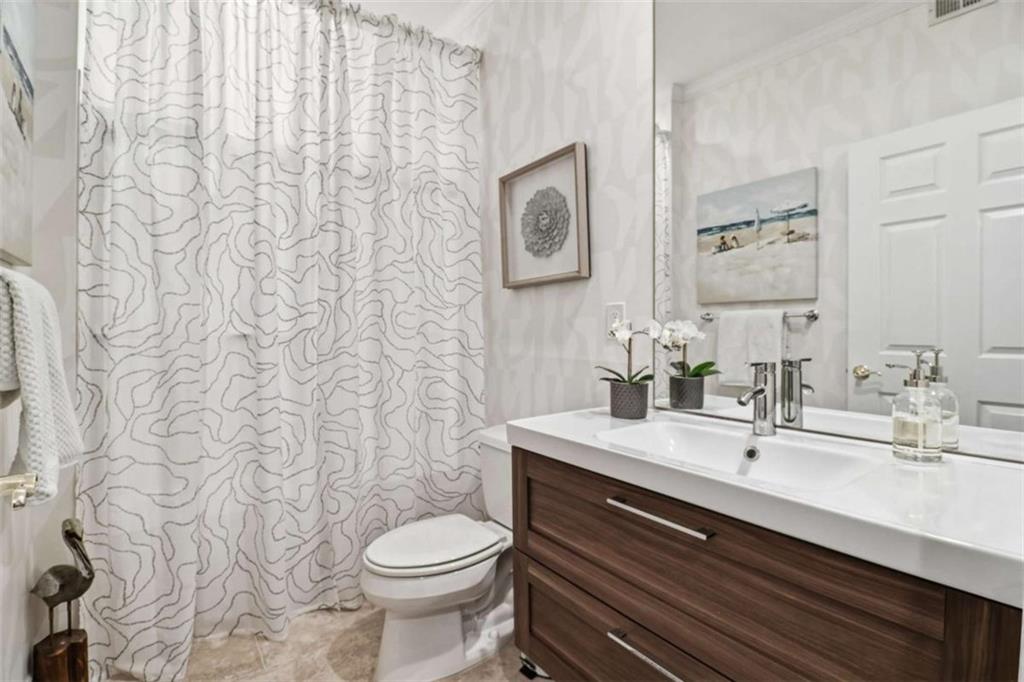 3047 Lenox Road Northeast, Unit 1108 Atlanta, GA 30324 - Photo 14 of 32 a bathroom with a toilet sink and mirror