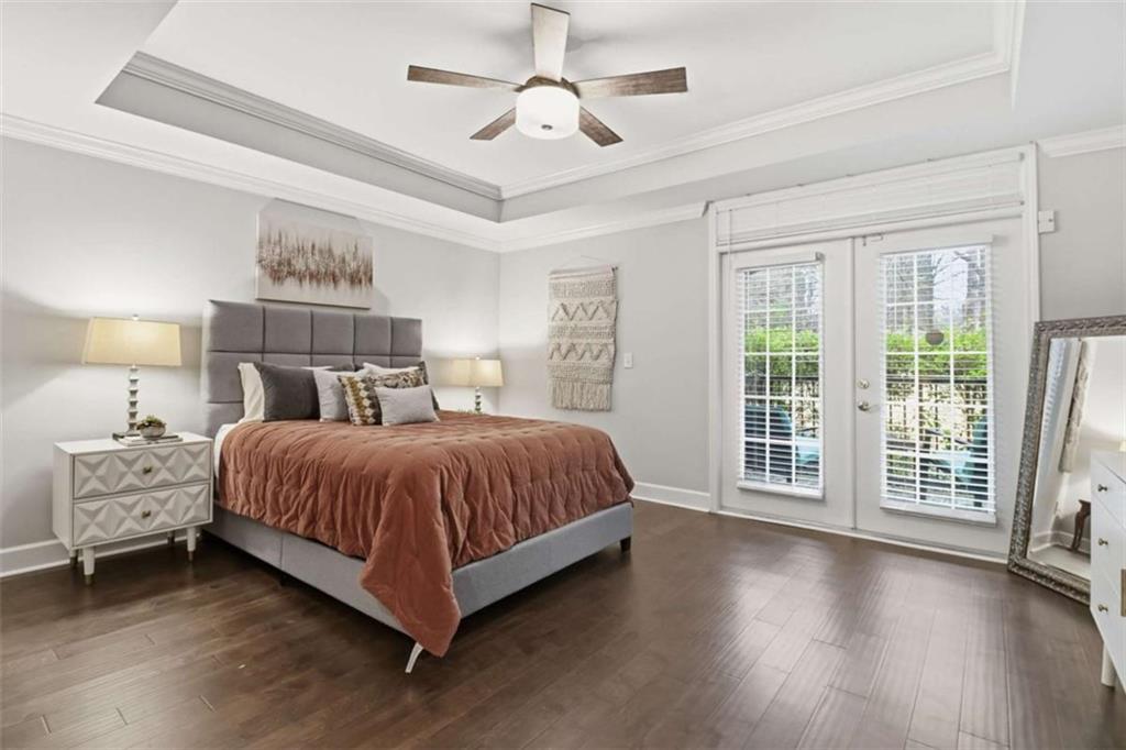3047 Lenox Road Northeast, Unit 1108 Atlanta, GA 30324 - Photo 16 of 32 a spacious bedroom with a balcony a bed and wooden floor