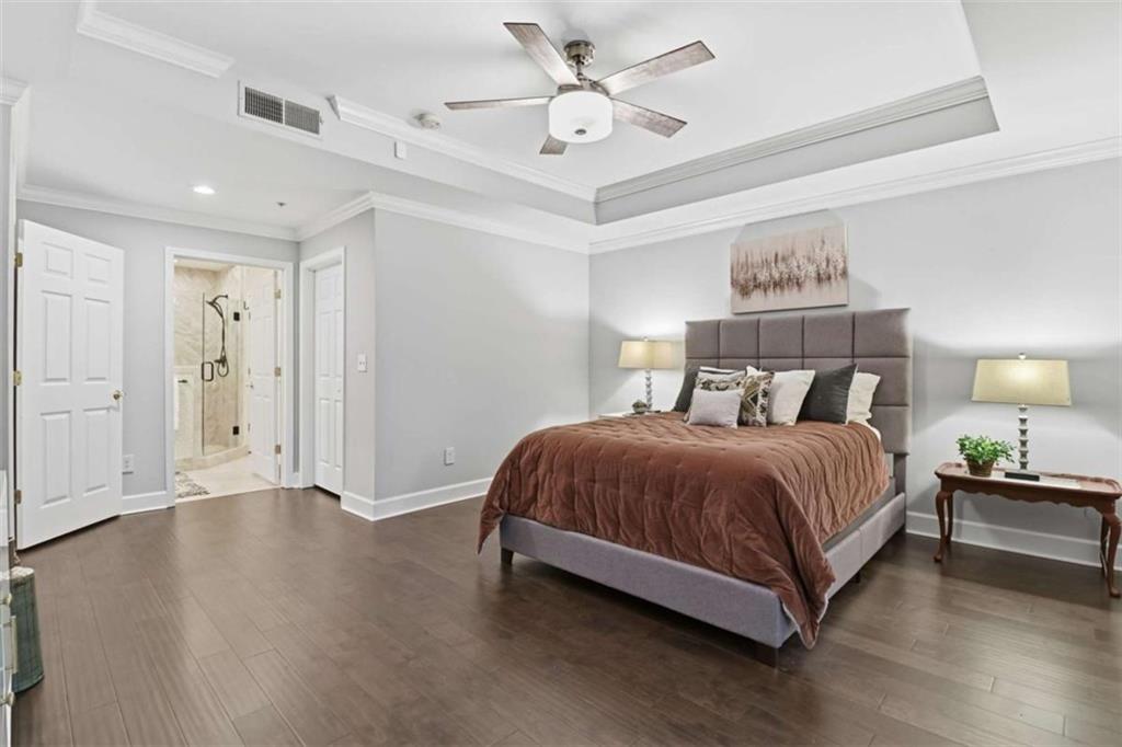 3047 Lenox Road Northeast, Unit 1108 Atlanta, GA 30324 - Photo 17 of 32 a spacious bedroom with a bed and a chandelier