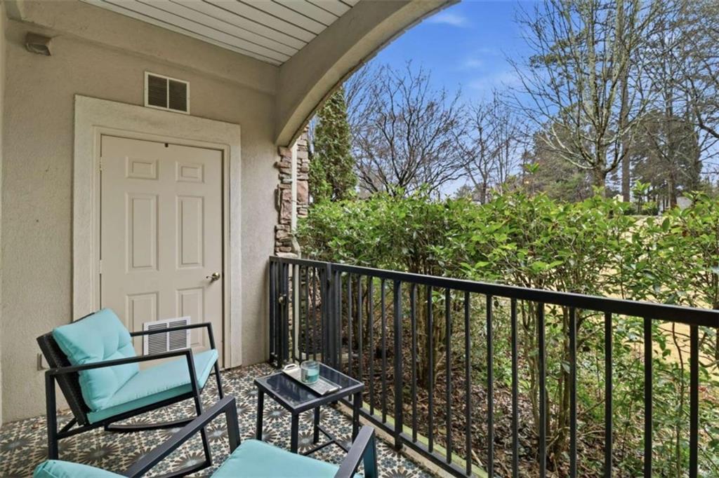 3047 Lenox Road Northeast, Unit 1108 Atlanta, GA 30324 - Photo 20 of 32 a balcony with table and chairs