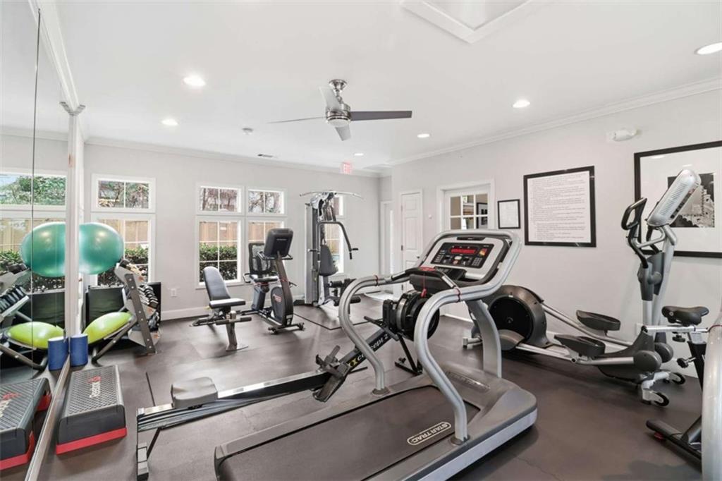 3047 Lenox Road Northeast, Unit 1108 Atlanta, GA 30324 - Photo 25 of 32 a room with gym equipment and large mirror