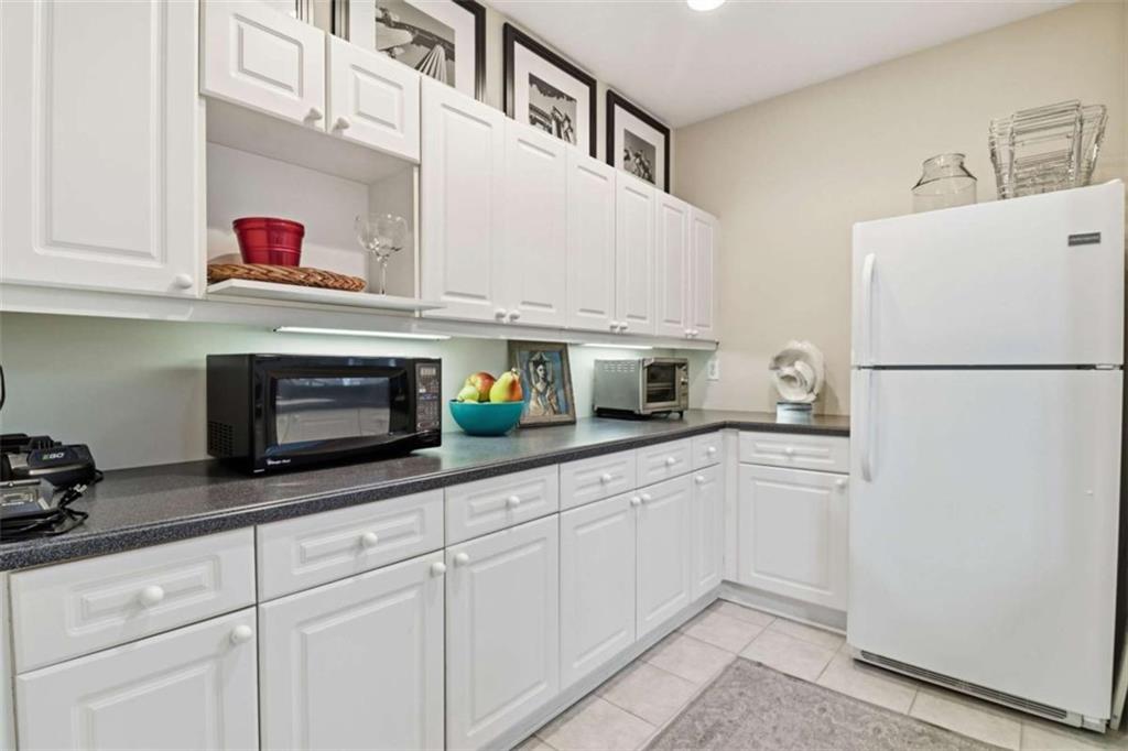 3047 Lenox Road Northeast, Unit 1108 Atlanta, GA 30324 - Photo 30 of 32 a kitchen with stainless steel appliances white cabinets and a refrigerator