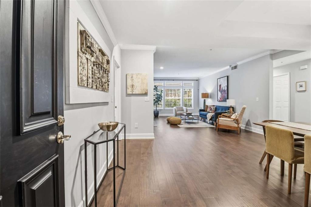 3047 Lenox Road Northeast, Unit 1108 Atlanta, GA 30324 - Photo 4 of 32 a living room with furniture and a wooden floor