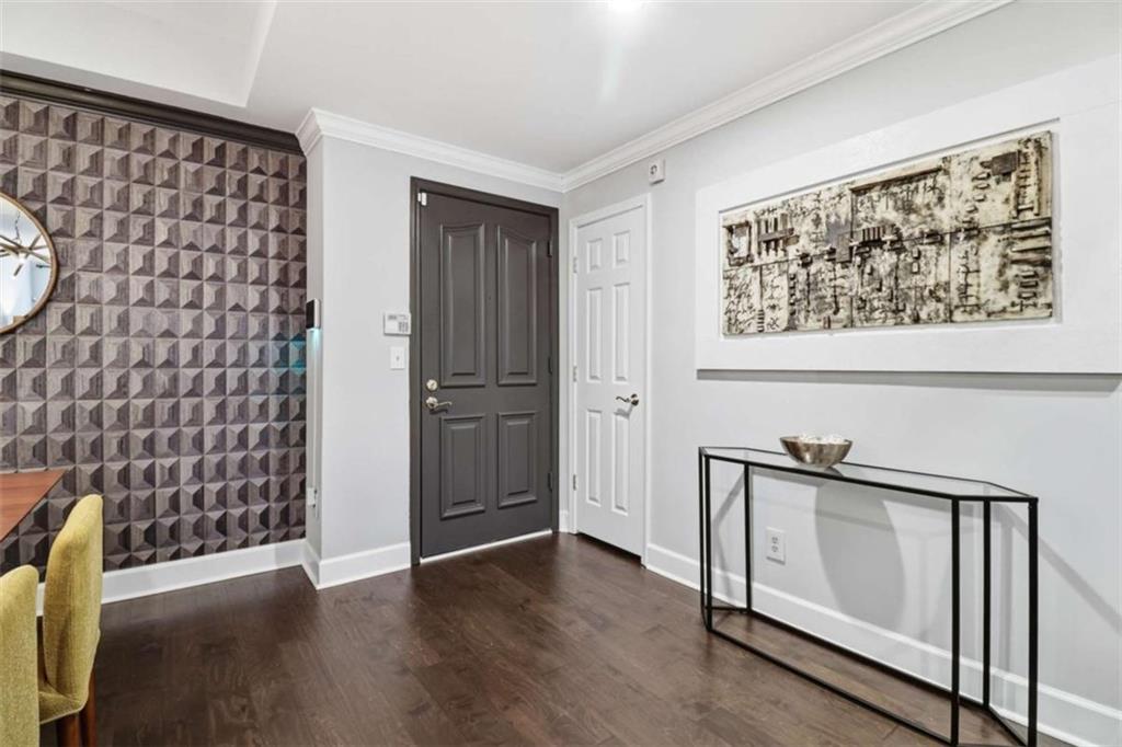 3047 Lenox Road Northeast, Unit 1108 Atlanta, GA 30324 - Photo 5 of 32 a view of an empty room with wooden floor and a window