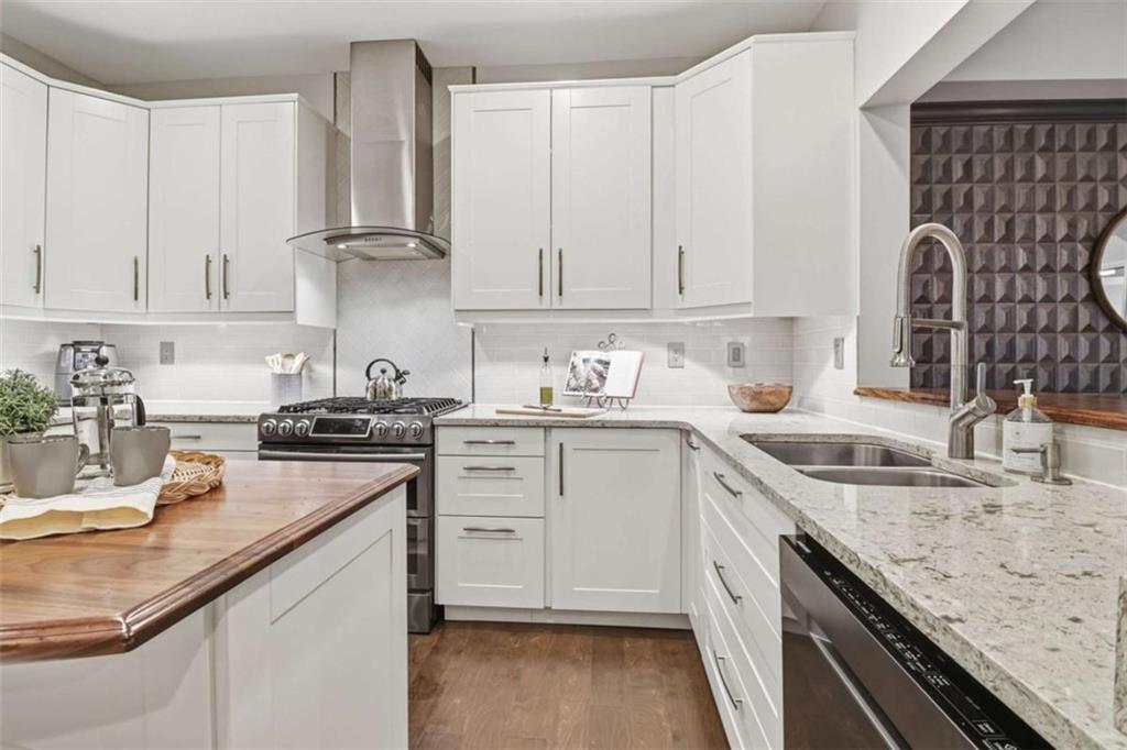 3047 Lenox Road Northeast, Unit 1108 Atlanta, GA 30324 - Photo 10 of 32 a kitchen with granite countertop a sink stove and cabinets