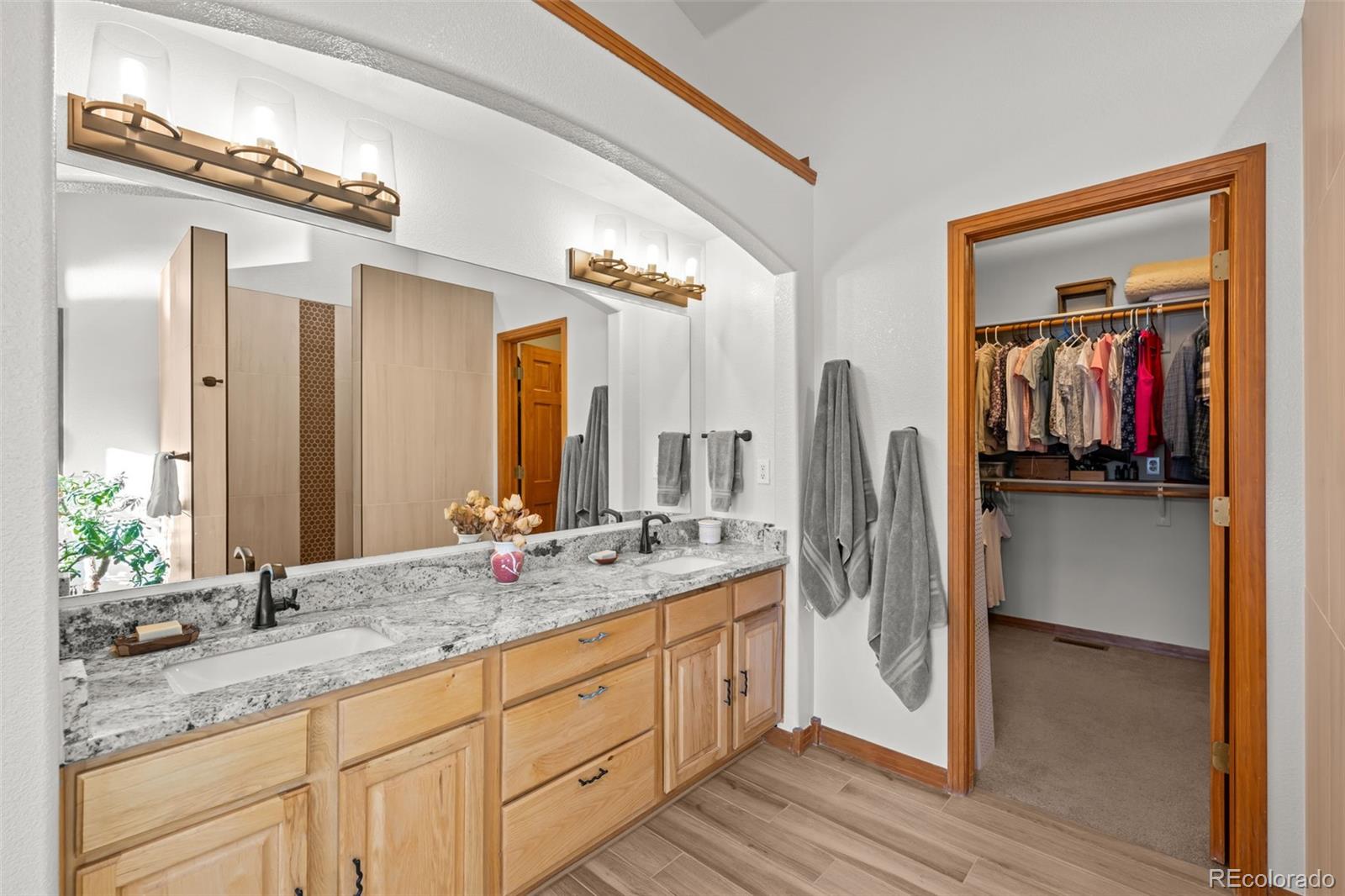 44 Forest Ridge Circle Bailey, CO 80421 - Photo 17 of 50 a bathroom with a granite countertop sink and a mirror