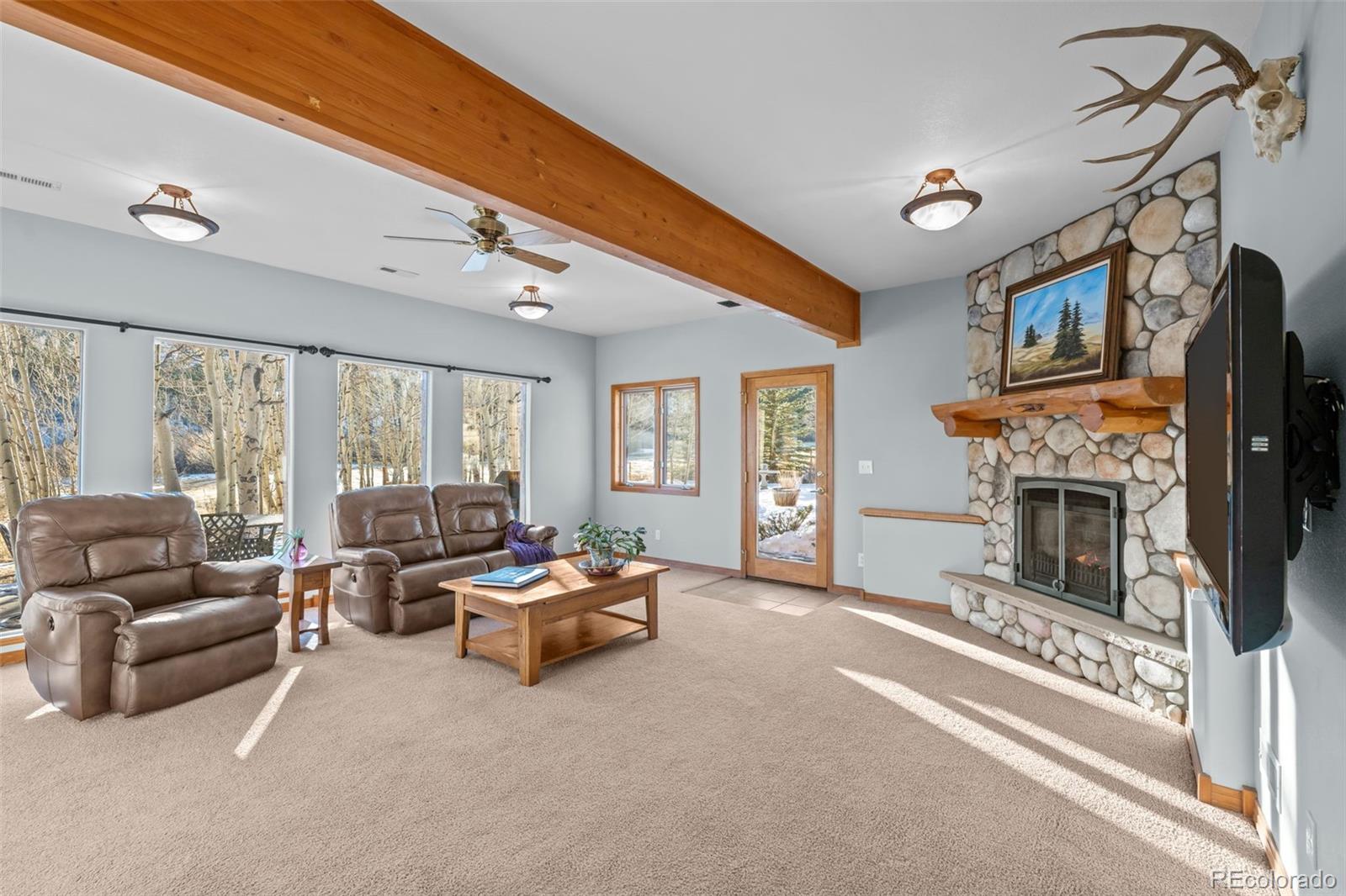 44 Forest Ridge Circle Bailey, CO 80421 - Photo 21 of 50 a living room with furniture and a fireplace