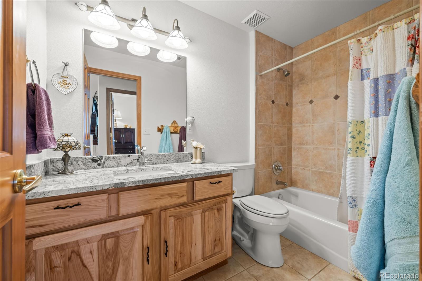 44 Forest Ridge Circle Bailey, CO 80421 - Photo 23 of 50 a bathroom with a granite countertop sink a toilet and a bathtub